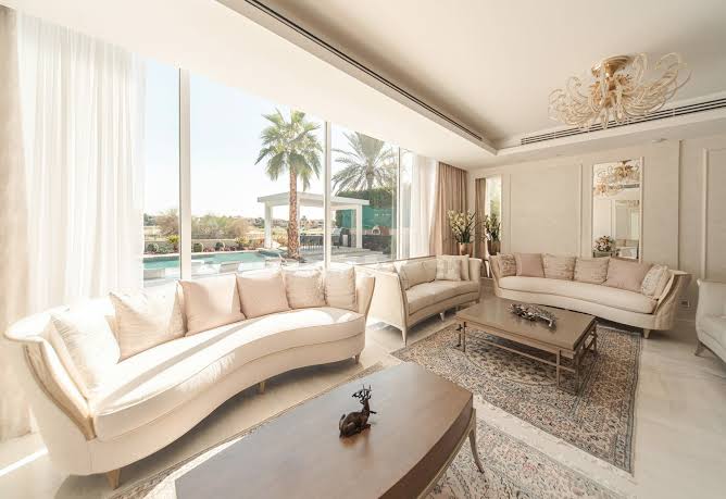 Personalized luxury villa living room interior with large windows and pool view